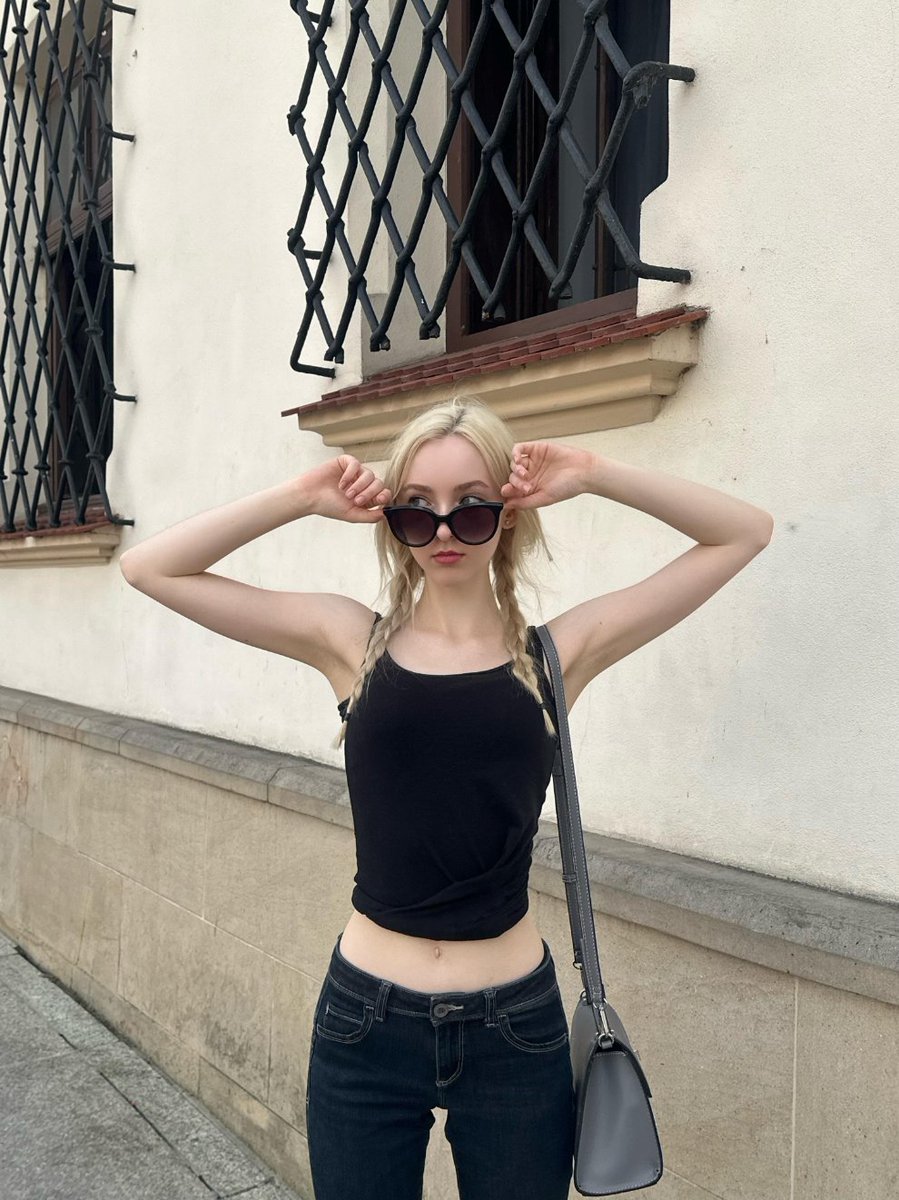SilentHaltca0's tweet photo. Black tank, double braids, strolling old town streets. Sunglasses on, everything settles. Old walls, cobblestones, passing shadows as background. No need to pose, shots come as I walk. Black fits carry quiet coolness, clear lines, not disturbing, not disturbed 🖤 https://t.co/esBzUTcktw