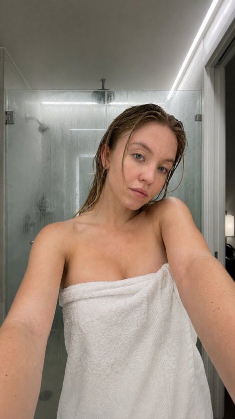 wiliam_web3's tweet photo. A shower before dinner!😉🚿

Scarlett Johansson, Megan Fox, Sydney Sweeney, Sadie Sink

Nano banana prompt :

{
  "type": "image_prompt",
  "version": "1.0",

  "description": {
    "subject": {
      "identity": "Use uploaded reference face exactly",

      "appearance": {
        "face": "Ultra realistic woman with natural wet skin texture after shower, visible water droplets on forehead, cheeks, shoulders and collarbone, realistic skin pores, soft neutral expression, natural glossy lips, minimal makeup look, authentic damp skin reflections",

        "hair": "Wet hair slicked back naturally with damp strands framing face and neck, realistic moisture texture and shine",

        "body": "Slim feminine physique with realistic anatomy and natural proportions"
      }
    },

    "clothing": {
      "outfit": {
        "details": [
          "Soft white luxury bath towel wrapped around body",
          "Realistic fluffy towel fabric texture",
          "Natural towel folds and wrapped styling",
          "Fresh post-shower appearance"
        ]
      }
    },

    "pose": {
      "details": [
        "Close-up selfie style framing",
        "Upper body leaning slightly forward toward camera",
        "Both arms extended naturally as if holding phone",
        "Head tilted slightly downward and toward camera",
        "Relaxed shoulders",
        "Soft tired expression after shower",
        "Natural candid bathroom moment"
      ]
    },

    "environment": {
      "location": "Modern luxury bathroom",

      "background": [
        "Large glass shower enclosure with light steam condensation",
        "Soft beige marble bathroom walls",
        "Minimal modern bathroom interior",
        "Subtle water marks on shower glass",
        "Clean luxury hotel-style bathroom atmosphere",
        "Bright neutral bathroom tones",
        "Elegant contemporary design"
      ]
    },

    "lighting": {
      "type": "Ultra realistic soft bathroom lighting",

      "effects": [
        "Bright diffused overhead bathroom lights",
        "Soft reflections on wet skin",
        "Natural moisture highlights on forehead and shoulders",
        "Balanced warm-neutral indoor tones",
        "Realistic bathroom ambience",
        "Gentle shadows around jawline and collarbone",
        "Natural skin color rendering",
        "Authentic post-shower glow",
        "Professional candid beauty photography lighting"
      ]
    },

    "camera": {
      "angle": "Close eye-level selfie perspective",

      "framing": "Upper-body vertical composition",

      "focus": "Sharp focus on face and wet skin texture with softly blurred bathroom background",

      "style": "Ultra realistic candid beauty photography"
    },

    "watermark": {
      "details": [
        "Small subtle watermark text 'Glena jenner'",
        "Placed discreetly in bottom corner",
        "Very low opacity elegant font",
        "Does not distract from composition"
      ]
    },

    "quality": {
      "render": "Ultra photorealistic 8k",

      "details": [
        "Hyper realistic wet skin texture",
        "Detailed water droplets",
        "Natural facial details",
        "Realistic bathroom reflections",
        "Authentic lighting and shadows",
        "Professional editorial beauty quality",
        "Ultra detailed towel fabric",
        "True-to-life skin tones",
        "Luxury bathroom atmosphere"
      ]
    }
  }
}