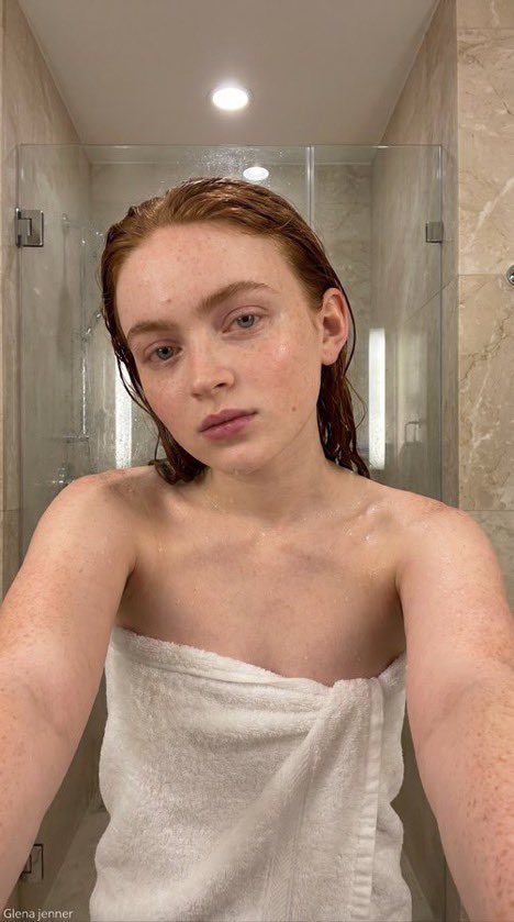 wiliam_web3's tweet photo. A shower before dinner!😉🚿

Scarlett Johansson, Megan Fox, Sydney Sweeney, Sadie Sink

Nano banana prompt :

{
  "type": "image_prompt",
  "version": "1.0",

  "description": {
    "subject": {
      "identity": "Use uploaded reference face exactly",

      "appearance": {
        "face": "Ultra realistic woman with natural wet skin texture after shower, visible water droplets on forehead, cheeks, shoulders and collarbone, realistic skin pores, soft neutral expression, natural glossy lips, minimal makeup look, authentic damp skin reflections",

        "hair": "Wet hair slicked back naturally with damp strands framing face and neck, realistic moisture texture and shine",

        "body": "Slim feminine physique with realistic anatomy and natural proportions"
      }
    },

    "clothing": {
      "outfit": {
        "details": [
          "Soft white luxury bath towel wrapped around body",
          "Realistic fluffy towel fabric texture",
          "Natural towel folds and wrapped styling",
          "Fresh post-shower appearance"
        ]
      }
    },

    "pose": {
      "details": [
        "Close-up selfie style framing",
        "Upper body leaning slightly forward toward camera",
        "Both arms extended naturally as if holding phone",
        "Head tilted slightly downward and toward camera",
        "Relaxed shoulders",
        "Soft tired expression after shower",
        "Natural candid bathroom moment"
      ]
    },

    "environment": {
      "location": "Modern luxury bathroom",

      "background": [
        "Large glass shower enclosure with light steam condensation",
        "Soft beige marble bathroom walls",
        "Minimal modern bathroom interior",
        "Subtle water marks on shower glass",
        "Clean luxury hotel-style bathroom atmosphere",
        "Bright neutral bathroom tones",
        "Elegant contemporary design"
      ]
    },

    "lighting": {
      "type": "Ultra realistic soft bathroom lighting",

      "effects": [
        "Bright diffused overhead bathroom lights",
        "Soft reflections on wet skin",
        "Natural moisture highlights on forehead and shoulders",
        "Balanced warm-neutral indoor tones",
        "Realistic bathroom ambience",
        "Gentle shadows around jawline and collarbone",
        "Natural skin color rendering",
        "Authentic post-shower glow",
        "Professional candid beauty photography lighting"
      ]
    },

    "camera": {
      "angle": "Close eye-level selfie perspective",

      "framing": "Upper-body vertical composition",

      "focus": "Sharp focus on face and wet skin texture with softly blurred bathroom background",

      "style": "Ultra realistic candid beauty photography"
    },

    "watermark": {
      "details": [
        "Small subtle watermark text 'Glena jenner'",
        "Placed discreetly in bottom corner",
        "Very low opacity elegant font",
        "Does not distract from composition"
      ]
    },

    "quality": {
      "render": "Ultra photorealistic 8k",

      "details": [
        "Hyper realistic wet skin texture",
        "Detailed water droplets",
        "Natural facial details",
        "Realistic bathroom reflections",
        "Authentic lighting and shadows",
        "Professional editorial beauty quality",
        "Ultra detailed towel fabric",
        "True-to-life skin tones",
        "Luxury bathroom atmosphere"
      ]
    }
  }
}