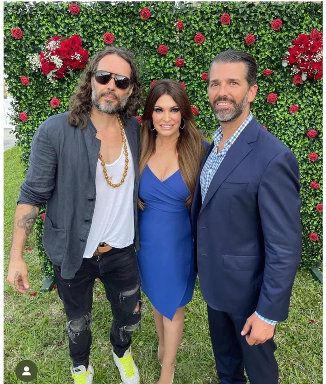 MAGAts_Exposed's tweet photo. "if you care about democracy, if you care about freedom, I don't know how you could do anything other than vote for Donald Trump"
Behold the miraculous transfiguration of alleged sexual predator MAGAt Russell Brand, who has seamlessly traded his skin-tight leather trousers for a camera-ready baptismal gown. It is truly inspiring to watch an aging influencer lock eyes with the Almighty and suddenly clutch a Holy Bible like the ultimate shield against a Southwark Crown Court docket. There is nothing quite like the threat of multiple criminal counts of rape, sexual assault, and indecent assault from six different women to make a man sprint toward a pristine new persona of divine redemption.
The charges agaisnt Brand include:
1999 (Rape): An alleged rape occurring in a hotel room in Bournemouth during a Labour Party conference event.
2001 (Indecent Assault): Brand is accused of grabbing a woman's forearm and attempting to force her into a male restroom at a television studio in Westminster.
2004 (Oral Rape & Sexual Assault): Two separate charges stemming from an incident at a bar during a birthday party in Westminster, involving oral rape and the non-consensual touching of a woman's breasts.
2004–2005 (Sexual Assault): Brand is accused of trapping a woman against a wall, groping her, and forcefully kissing her at a radio station.
2009 (Rape & Sexual Assault): Two additional charges authorized by the Metropolitan Police involving two separate women.
With his criminal trial scheduled for October 2026, Brand has masterfully pivoted from preaching anti-capitalist anarchy to masquerading as a persecuted conservative martyr. The sheer audacity required to rebrand a harrowing history of sexual misconduct allegations into a cozy narrative of spiritual warfare is breathtaking. Apparently, in the gospel according to Russell, the waters of baptism do double duty as a convenient legal eraser to wash away a joint journalistic exposé.
Naturally, this divine reinvention wouldn't be complete without a pilgrimage to the Trump family inner circle. Auditioning for the role of Donald Trump’s chief cheerleader at the Republican National Convention and wearing a "Make Jesus First Again" hat is the perfect final act for a man who used to tell the youth that voting was a scam. It turns out that when the world remembers your alleged victims, the quickest way to find sanctuary is to wrap yourself in the American flag, hold a Bible, and pretend your day in court is just a conspiracy against your newfound piety.