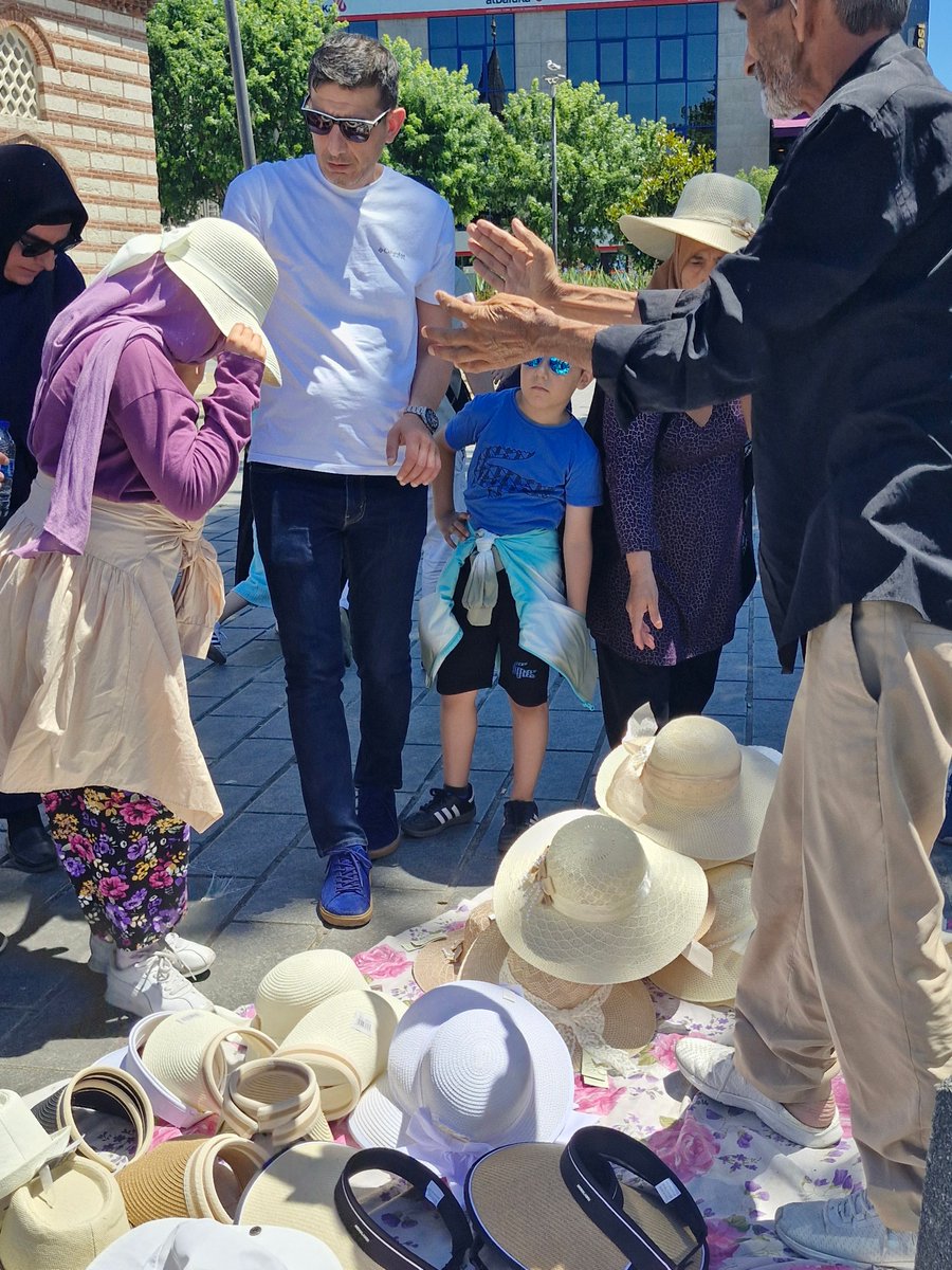 IOIILisaMorrow's tweet photo. No matter where you are in #summerinturkey wearing hat is essential. Forgot to pack one? Don't panic! Just look for someone with hats laid out on a sheet. If you enjoy my tweets please share &amp; like them &amp; help me spread word about #everydayextraordinary of #istanbullife https://t.co/8dj570Cp8A