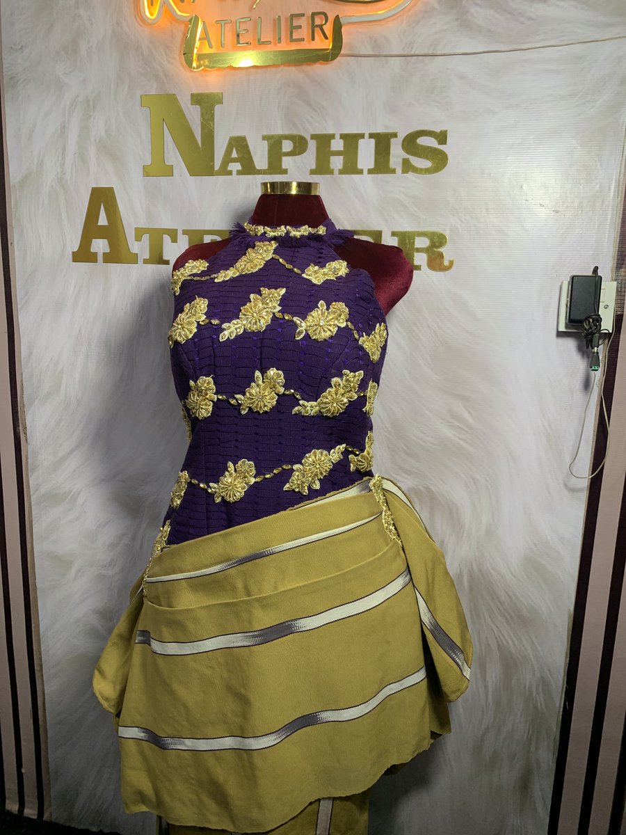 naphisofficial's tweet photo. Two Aso-Oke, One dress. 

Crafted with rich purple Àṣọ Òkè and patterned handwoven Àṣọ Òkè accents, this piece is thoughtfully designed with intricate gold applique and gem studs that catch the light with every movement.

A fusion of tradition and elegance, it honors the beauty of African craftsmanship while embracing a contemporary silhouette. Every detail speaks of culture, artistry, and the confidence of a woman who wears her heritage proudly.