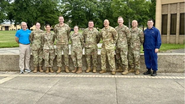 A group of airmen and civilians stand together for the C-Stars Omaha U.S. Public Health Service brief on Ebola response training.