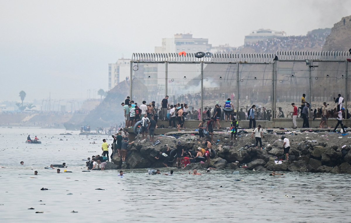 sentdefender's tweet photo. Reuters reports that an estimated 49,000 migrants crossed, or attempted to cross, into the Spanish enclave of Ceuta from Morocco overnight, prompting Spain to deploy additional military and police forces while Moroccan authorities used water cannons and reinforced border security to stem the surge.

According to Reuters, authorities in Ceuta said nine bodies have been recovered, while clashes left multiple vehicles burned and stampedes injured migrants as crowds attempted to breach the border or swim around it. The latest surge highlights the continued pressure on Ceuta, one of the European Union's only land borders with Africa and a recurring flashpoint for irregular migration into Europe.

Source: https://t.co/bF2zEEK6QL