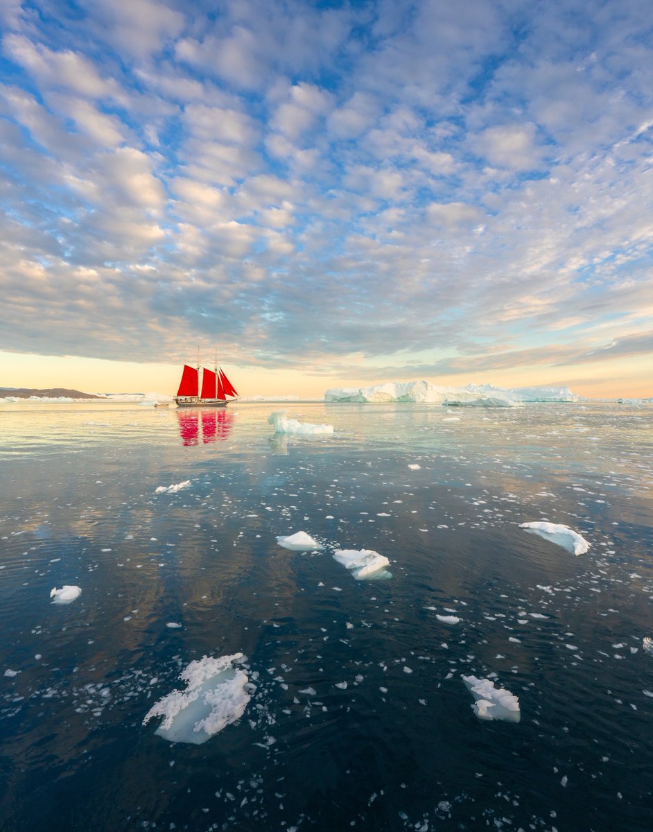 albertdrosphoto's tweet photo. Earlier this month I had the opportunity to work with Elsi, this beautiful red-sailed ship. It looked so tiny in between the massive icebergs of Greenland. https://t.co/gBY1l372iT