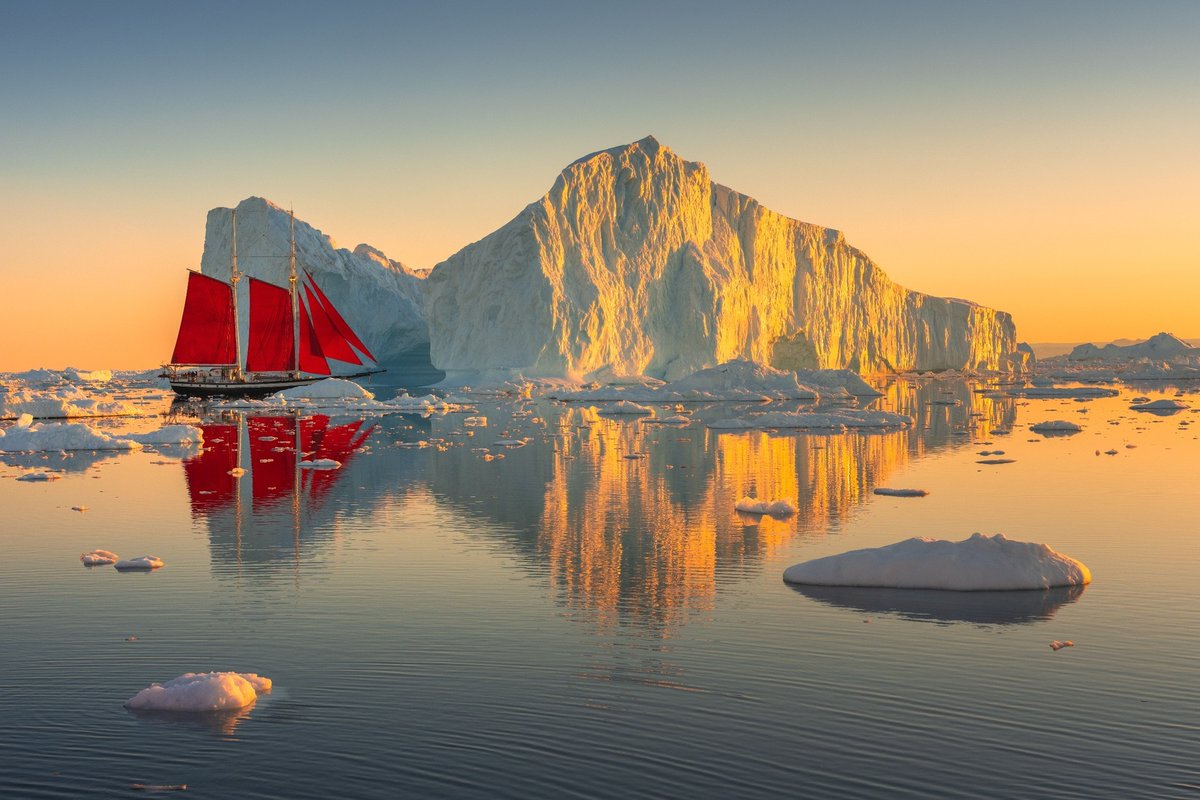 albertdrosphoto's tweet photo. Earlier this month I had the opportunity to work with Elsi, this beautiful red-sailed ship. It looked so tiny in between the massive icebergs of Greenland. https://t.co/gBY1l372iT