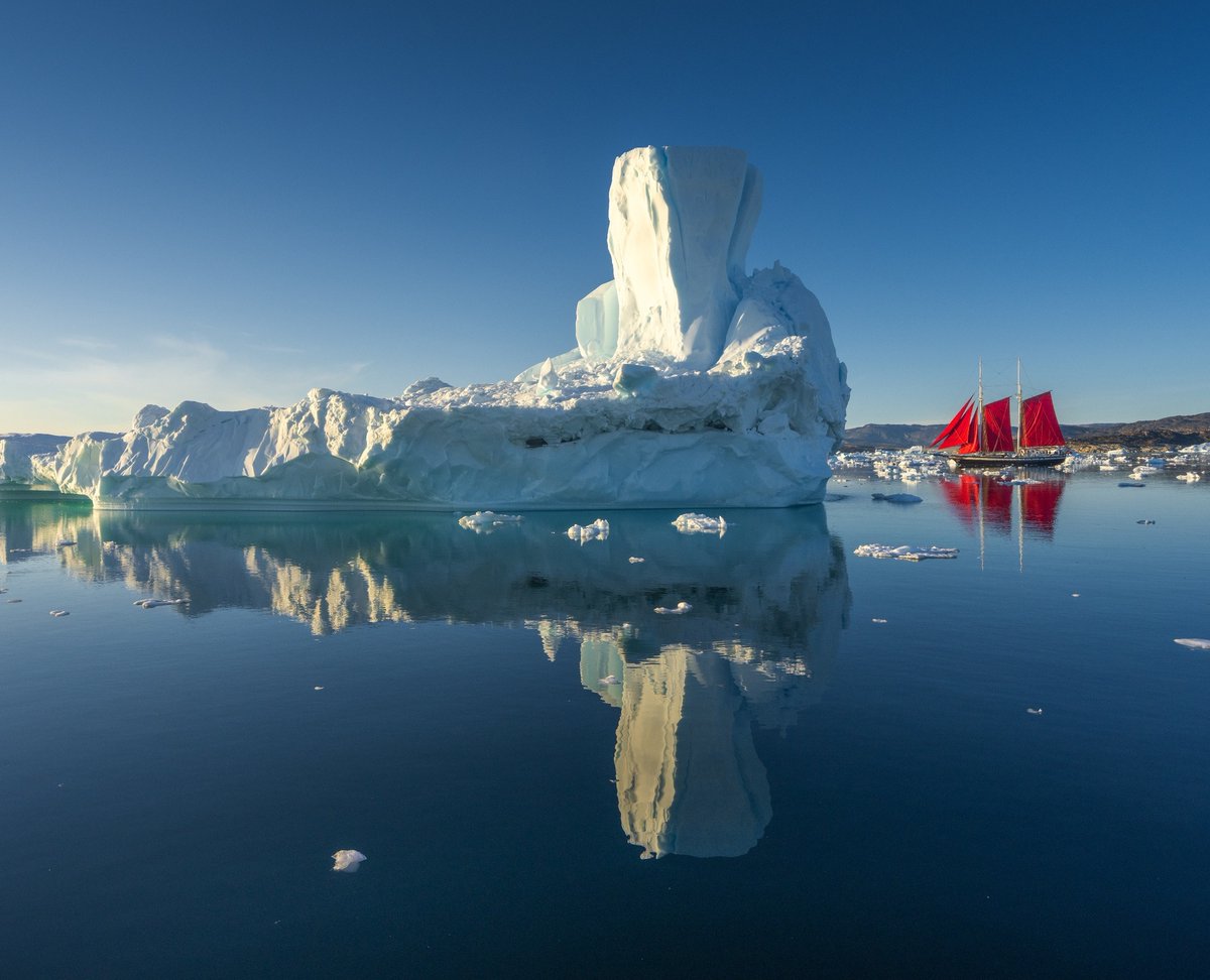 albertdrosphoto's tweet photo. Earlier this month I had the opportunity to work with Elsi, this beautiful red-sailed ship. It looked so tiny in between the massive icebergs of Greenland. https://t.co/gBY1l372iT