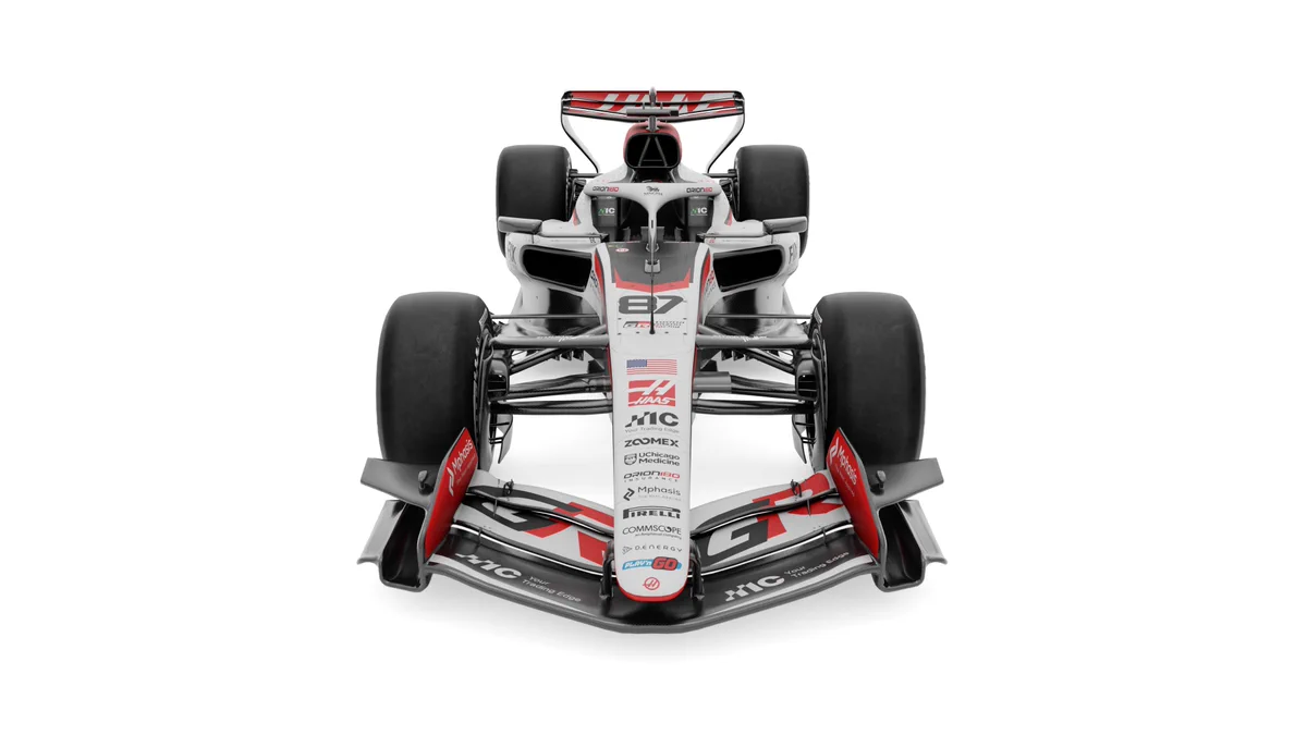 Front view of a sleek Formula 1 race car with prominent aerodynamic wings and large tires on a white background.
