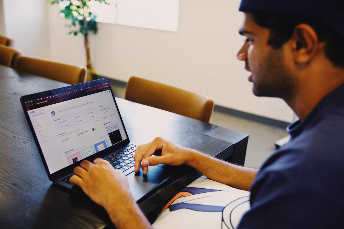 Person using a laptop at a desk with a focus on the screen.