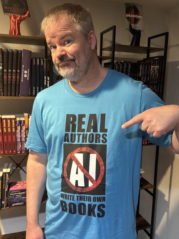 JeffStrand's tweet photo. It's the FINAL DAY to get 20% off everything at Bridgett Nelson's online store! Books! All kinds of apparel, including the shirt the lovely model is wearing below!  Just use discount code LAKECABIN. https://t.co/3WLskDV7sI https://t.co/1dgEvRpUJl