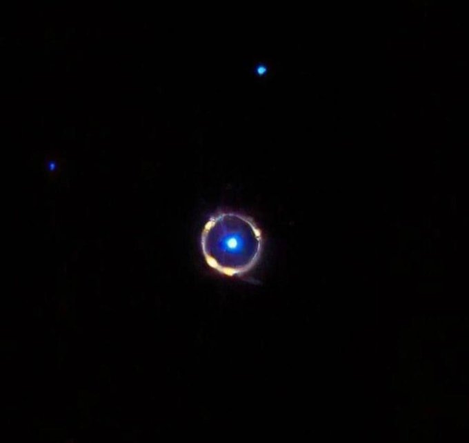 konstructivizm's tweet photo. A Perfect Cosmic Ring: Webb Captures Rare Gravitational Lensing 🔭

The James Webb Telescope has captured an image of the galaxy SPT-S J041839-4751.8, located 12 billion light-years away. The image reveals a rare "Einstein Ring": light from a distant background galaxy has been distorted to form a perfect circle around an object positioned directly in the foreground.

This natural phenomenon arises from the massive warping of spacetime caused by the gravity of a nearby galaxy.