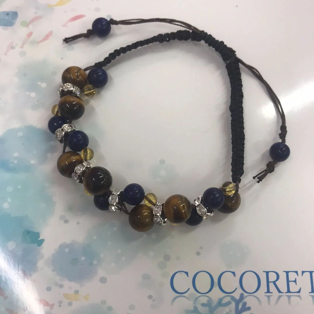 cocorety43's tweet photo. 【障害者ブランド・ココリティ】杏樹作　ブレスレット「マクラメ編みのブレスレット（黒）」NO.5524　H

タイガーアイの深い輝きとラピスラズリの深い青のコントラストが上品。シルバーのキラキラが華やかさをそえ、マクラメ編みで誰でもフィット。天然石の温かみが魅力の源です。￥1,800 https://t.co/nzraEMQmZP