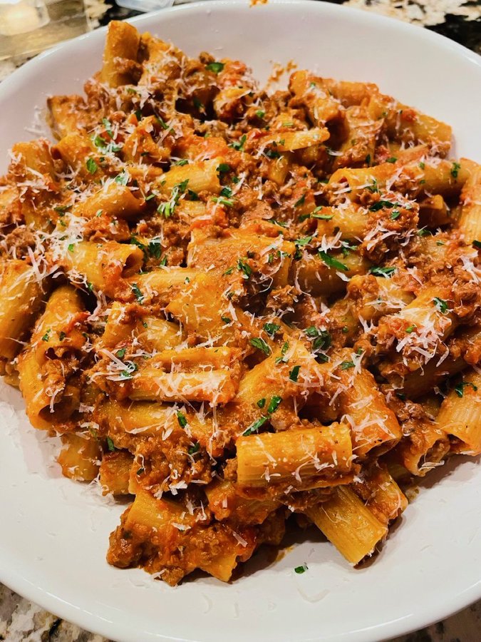 coookwithchris's tweet photo. The BEST Bolognese You'll Ever Make:

Ingredients:

1 medium yellow onion
1 celery stalk
1 carrot
1 lb ground beef (85/15)
4 cloves garlic, minced
2 cups beef broth
½ cup dry white wine
1 15oz can crushed tomatoes
3 tbsp tomato paste
3 tbsp balsamic vinegar
2 tsp dried oregano
½ tsp crushed red pepper (or more to taste)
1 bay leaf
1 cup whole milk
Salt and pepper to taste

Put the onion, celery and carrot in a food processor and pulse until finely chopped. If you don’t have a food processor, chop as fine as possible with a knife.

Heat 1 tbsp of oil on medium high heat on a large saucepan. Add the finely chopped vegetables with a pinch of salt, and cook until most of the moisture has cooked off (about 5-6 minutes).

Add a drop of more oil and add your garlic, then cook until fragrant (about 1 minute).

Move the vegetables to the side and add the ground beef with a pinch of salt. Cook until no longer pink inside. When the beef is ¾ of the way cooked, start mixing it in with the vegetables.

When the beef is fully cooked, add the white wine and cook until most of the liquid has evaporated.

Add the beef broth, crushed tomatoes, tomato paste, balsamic vinegar, oregano, crushed red pepper, bay leaf and a pinch of salt. Simmer until the sauce has thickened (about 1 hour).

When the sauce has thickened, add the milk and cook for about 1 more hour, then season with salt and pepper.

Cook the rigatoni for about ¾ of the package instructions, then finish cooking in the sauce with a splash of pasta water and freshly grated parmesan.