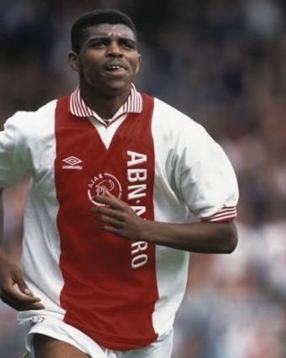 thecultballers's tweet photo. He was 6 foot 6 with a silk touch. Won a bizarre set of trophies across club and country. Underwent heart surgery at the peak of his career. And scored a Premier League hat-trick in fifteen minutes off the bench.

Happy 50th birthday, Nwankwo Kanu.

He grew up in Owerri, Nigeria, his name meaning "child born on Nkwo market day" in Igbo tradition. He broke through domestically with Iwuanyanwu Nationale and moved to Ajax in 1993 as a teenager.

He won three successive Eredivisie titles there and in 1995 he lifted every club trophy in the world, the Champions League, the UEFA Super Cup and the Intercontinental Cup in Tokyo. An unpredictable and intelligent player, known for using feints, scoop finishes, backheels and the outside of his boot.

In the summer of 1996 Kanu captained Nigeria's Olympic squad in Atlanta. In the semi-final against Brazil, with Nigeria down 2-3, he scored twice late to make it 4-3 and send Nigeria to the final. They won the final 3-2 against Argentina and took Olympic gold.

Weeks later, Inter Milan's medical staff, examining him ahead of a $4.7 million transfer from Ajax, discovered a serious defect in his aortic valve. Doctors believed his career was over. He had open heart surgery at the Cleveland Clinic in Ohio that November and missed most of the following season. He returned to professional football in 1997, won the UEFA Cup, and went on to play another fifteen seasons.

Arsenal signed him in February 1999, and his debut in the FA Cup lasted just ten minutes before he became the centre of controversy. A a 1-1 score, a Sheffield United player had gone down injured, the ball was kicked out so he could get treatment, and when play resumed with a throw-in meant to go straight back to the opposition goalkeeper. Kanu, new to the country and unaware of the unwritten convention, intercepted it and set up the winning goal.

Sheffield United were furious. Arsène Wenger offered to replay the match. Arsenal won the replay too, 2-1 again, and the original result was wiped from the books.

His career quickly revived at Arsenal and later that year Kanu went on to score one of the most famous hat-tricks in Premier League history, coming off the bench against Chelsea and scoring three goals in fifteen minutes.

He won two Premier League titles at Arsenal, including the unbeaten Invincibles season in 2004, and two FA Cups. He moved to West Brom, then Portsmouth, where in 2008 he scored the only goal in the FA Cup final against Cardiff City, a third FA Cup winner's medal.

He retired in 2012. Between club and country, he ended up with a bizarre set of honours: a Champions League, a UEFA Cup, two Premier League titles, three FA Cups, an AFCON win, an Olympic gold medal, and two African Footballer of the Year awards.

In 2000, he founded the Kanu Heart Foundation, funding paediatric heart surgery for children across Africa who would never have had access to the kind of care that had saved his career.

He also went on to found his own club in Nigeria, Papilo FC, aimed at giving young Nigerian players a structured pathway into the game.

The streets remember Nwankwo Kanu.  🇳🇬