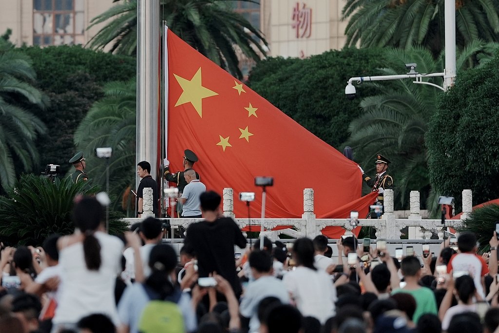 CGTNOfficial's tweet photo. Crowds gathered in Nanchang, birthplace of the Chinese People's Liberation Army (PLA), on August 1 for the national flag-raising ceremony as China marked the PLA's 99th founding anniversary. From the revolutionary era of fighting for national independence to the present day of peaceful development, the PLA has remained committed to safeguarding China's interests and its people. #ChinaSeen