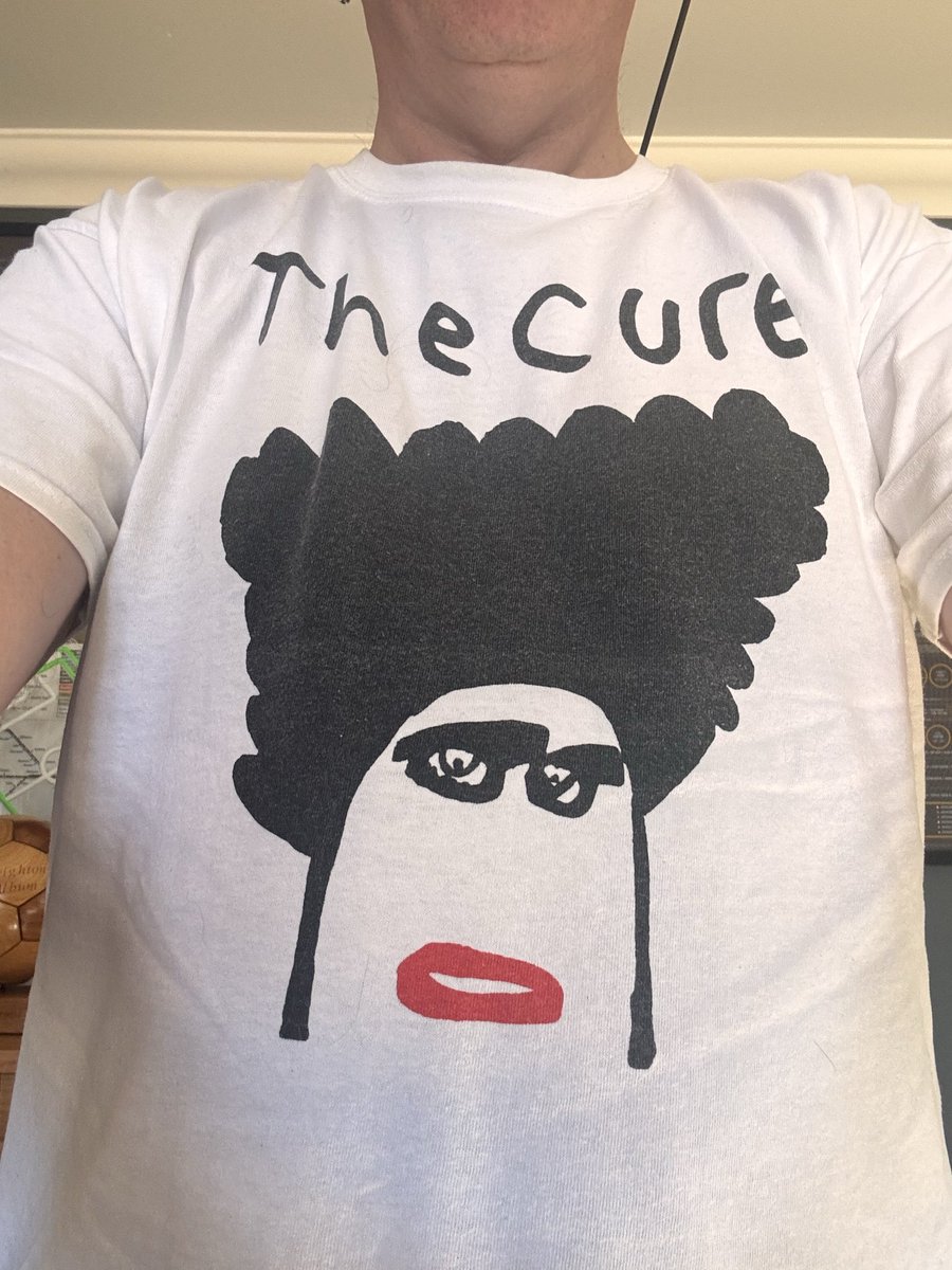 KieranMaguire's tweet photo. I’ve been asked by a few people about The Cure T shirt I wore on BBC News a bit earlier. It was designed by Marianne, who attends the Superstars centre in Worthing. Superstars provides creative projects for people aged 18+ with learning disabilities.

It’s a fab T shirt, as is Marianne, as is @thecure and you can buy them from here 👇

https://t.co/muo1AcSOhv