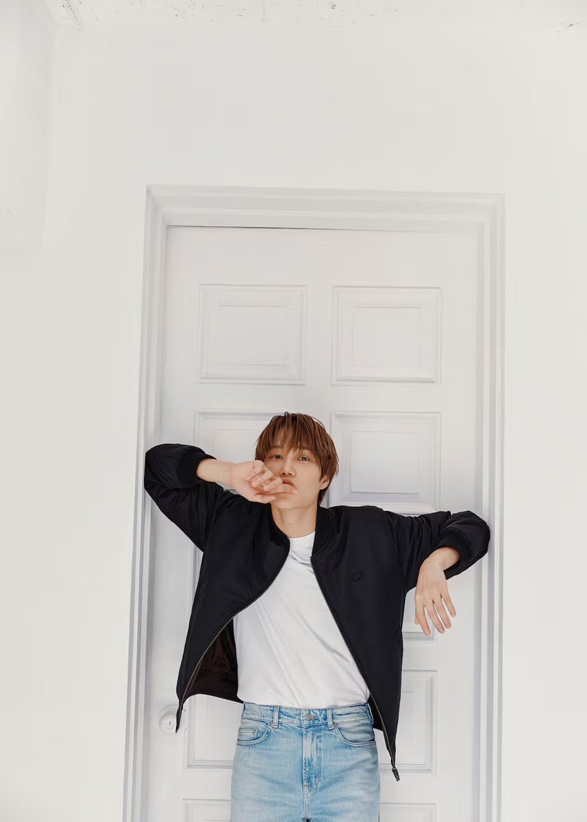 Jongin's tweet photo. Pristine cerulean denim anchors my silhouette, a timeless pairing for the sleek ebon jacket. Within these twin frames, a shared understanding of effortless style emerges, a nod to the enduring elegance synonymous with Lacoste. All the posture offers duality across the threshold. https://t.co/XBGDdfzwDW
