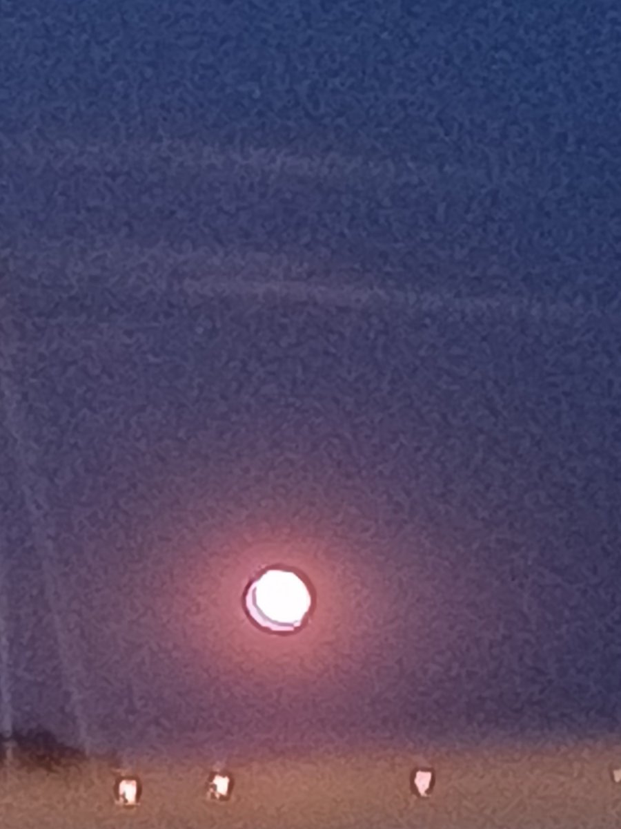 DidoWalker's tweet photo. Buck Moon 
My camera's eye
Sees nothing like the moon on high
Bright copper orange
Like its on fire
But my own lens sees
&amp; thats enough.
Winter &amp; its winds were rough
Now the desert sands
Glisten in the moons face
I love nature dawn to night
Nought can that erase.
#Buskerverse https://t.co/SPCgzqZcbg