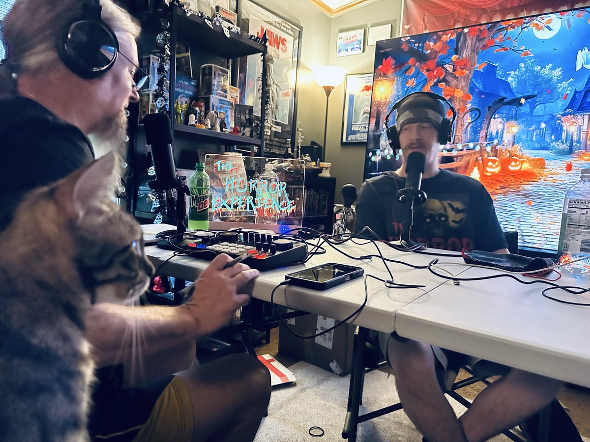 TheHorrorXP's tweet photo. Your lovely hosts working on the latest episode. The kitty is the lovely Savannah. 
#podcast #horror #cats https://t.co/cUz2YcFZBM