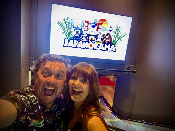 Me and my wife Polina in front of a Jet Lag poster.