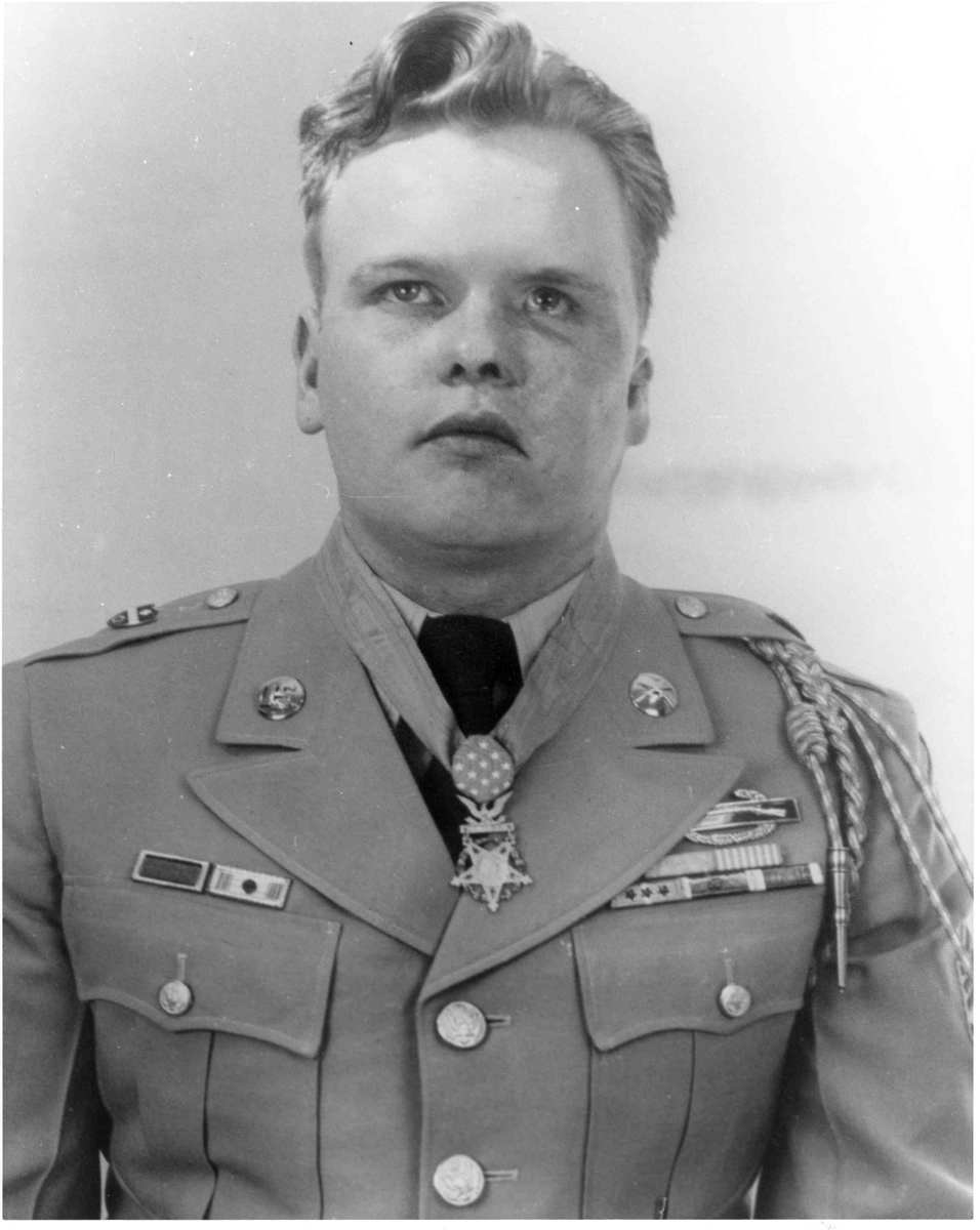 ForgottenWarPic's tweet photo. He had a grenade blast tear off part of his ear, then took a bullet through the face that went in his mouth and came out behind his ear. Most men are dead at that point. Einar Ingman stood up, killed the entire enemy machine gun crew in front of him, and only then let himself fall down.

Ingman was a farm kid from Wisconsin, a corporal in Korea in the winter of 1951. On February 26 his company was attacking a fortified enemy ridge near a place called Maltari when the two lead squads got caught in the open under murderous machine gun fire. Both squad leaders went down. Several other men were hit. The attack was dead in its tracks and starting to fall apart.

Ingman, just a corporal, took over. He pulled the two shattered squads together, reorganized them, moved from man to man telling them where to shoot and steadying them. Then he decided the only way forward was to go deal with the guns himself.

He charged the first machine gun position completely alone, got close, and knocked it out with a grenade. Then he turned toward the second gun, only about fifteen yards away, and kept coming.

That is when it happened. A grenade went off right next to him. The blast ripped his left ear half off and knocked him flat on the ground. As he was dragging himself back up onto his feet, an enemy rifleman shot him in the face. The bullet went through his mouth and tore out behind his already wounded ear.

By every reasonable expectation, that is the end of Einar Ingman. Head torn open, face shot through, on the ground.

Instead he got up. He rose to his feet, lifted his rifle, and killed every single man on that second gun crew before the wounds finally dropped him unconscious.

And that broke the whole enemy defense. With both guns silenced by one impossibly stubborn corporal, his squad took the objective, and more than a hundred enemy soldiers threw down their weapons and fled the ridge.

Ingman should not have lived. He was left with terrible wounds, lasting damage to his hearing and his face, years of surgery. But he did live. President Truman gave him the Medal of Honor, and Einar Ingman went home to Wisconsin and lived into his eighties, a quiet man who once got back up with half his head gone because his squad still needed him to.