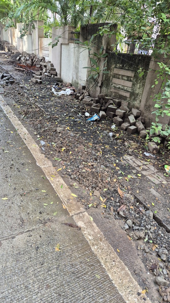 RoadMonk_Pune's tweet photo. Why is @PMCPune not sweeping streets regularly? It's been more than 5 weeks this road was cleaned. On top of that @mngl_in started pipeline work in the middle of monsoon. Bricks from the pavement dumped on the side.When will this get cleared? #shame https://t.co/afhLoXowIA