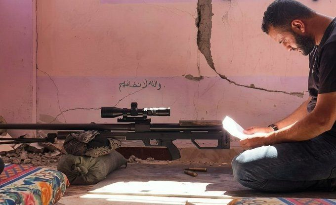 AbubakerAbedW's tweet photo. One of the Gaza armed resistance snipers contemplating in battle.

Then, some so-called Muslim politicians in the West, especially the US, who are now trying to salvage genocidal parties' reputations, are execrating them to woo more swarms of neo-liberal voters.

His name is Mohammed Mohammed Moin Al-Ja'bari. He wrote on the fractured wall, "I swear to Allah we never fear them."

Mohammed was locked and martyred in combat during the genocide.