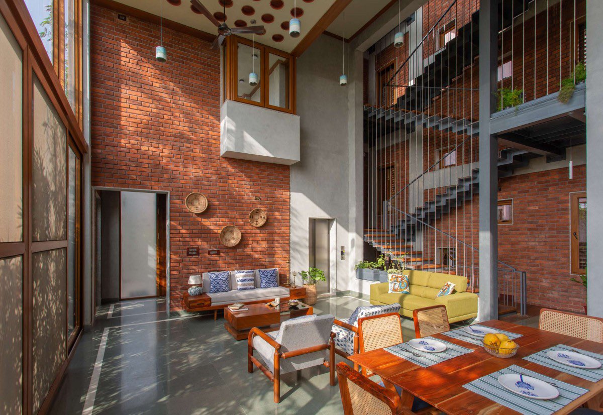 shavnyuyngah's tweet photo. A father in Chennai gave his daughter a house as a wedding gift. The architects built it almost entirely from brick, and used that “primitive” material to solve a problem glass and concrete usually can’t.

The Gully Home sits on an east facing plot overlooking the Bay of Bengal, meaning it takes the full force of the morning sun in exchange for the ocean view. ED+ Architecture’s answer was a double skinned facade: porotherm blocks on the inside, half cut bricks on the outside, cooling the interior while trapping heat in the wall itself rather than passing it through. Every window pairs an inward glass shutter with an outer aluminium louvered one, giving residents six different combinations of light, view, and airflow depending on the hour.

Inside, a triple height great room named after old Chennai’s street life pulls every bedroom’s bay window toward it, so the house stays visually connected floor to floor. The roof slab is layered with terracotta pots as fillers, cutting the concrete needed and the heat it would’ve absorbed.

Nothing about it reads primitive. It reads solved.

The Gully Home | ED+ Architecture
Chennai, India | 2022 | Photography: BRS Sreenag