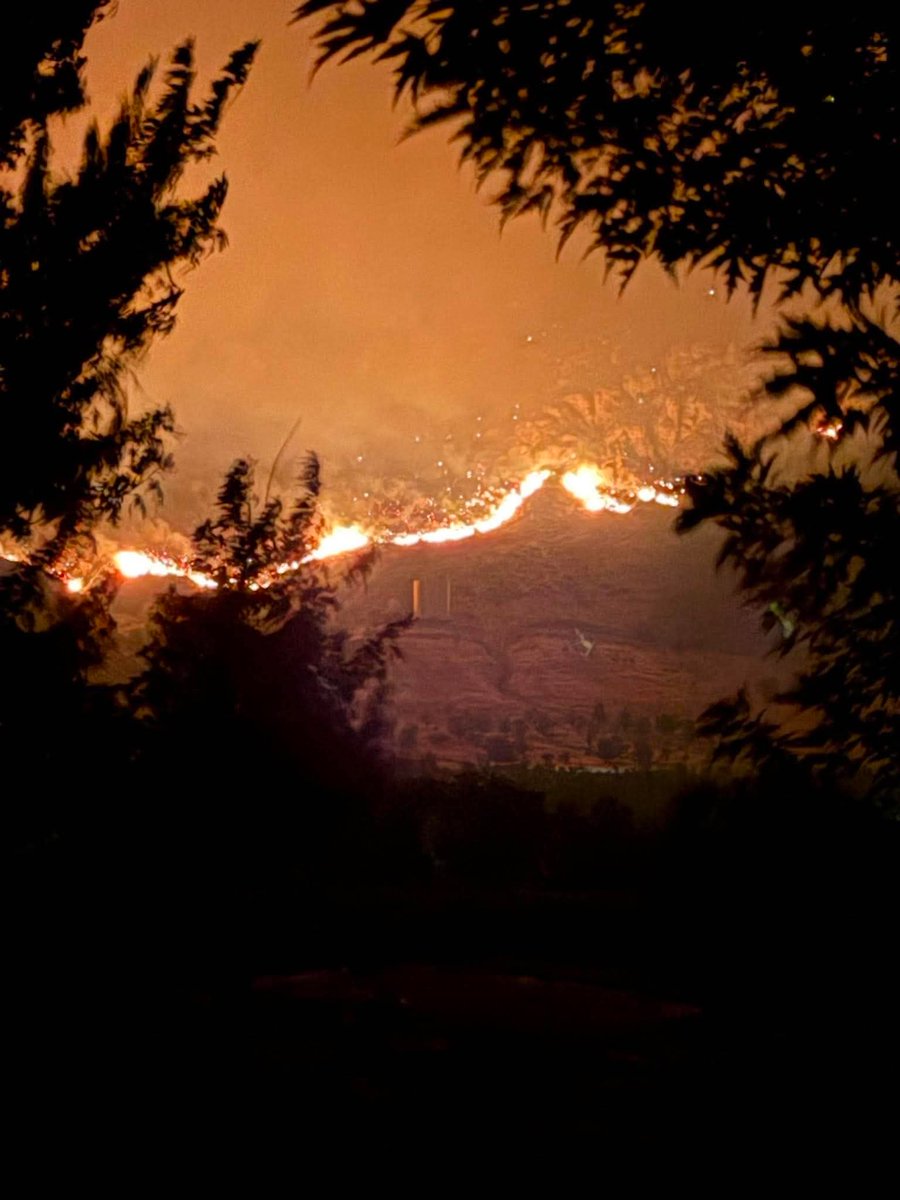 Bellingham_News's tweet photo. UPDATE: New photos show Sinlahekin Fire moving closer to Tonasket overnight

New images shared with Bellingham Metro News by Tuesday McAllister show the Sinlahekin Fire continuing to burn along the hillsides overlooking Tonasket as firefighters work through the night to slow its advance.

The latest photos capture long stretches of active fire, heavy smoke and glowing ridgelines just outside the community, highlighting how close the wildfire has come to populated areas. The fire’s glow can be seen from neighborhoods near the city as conditions remain dangerous.

Evacuation orders remain in effect for parts of the area, and officials continue urging residents to stay alert and follow all emergency instructions as the situation evolves.

Bellingham Metro News will continue providing updates as more information becomes available.

Photos courtesy of Tuesday McAllister, shared with permission.