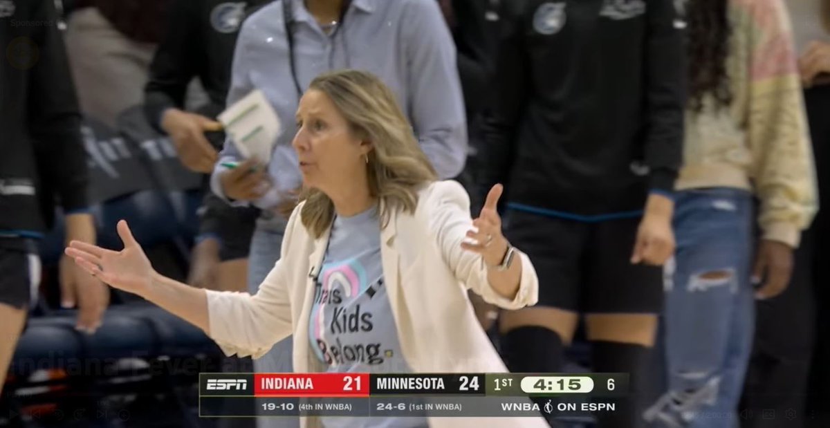Outkick's tweet photo. Minnesota Lynx head coach Cheryl Reeve wearing a “Trans Kids Belong” shirt against the Fever today https://t.co/wbQuMMMAJ3