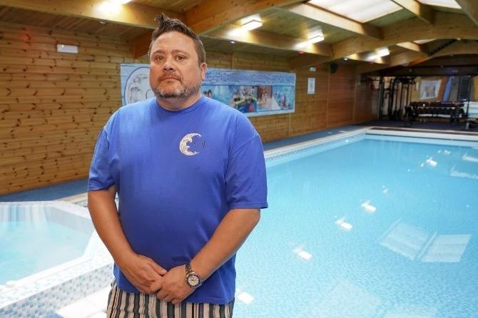 AllForProgress_'s tweet photo. Ossett has no public swimming pool. Jon Gardiner has one, at 67 Station Road, and for five months he opened it to the town. Schools came. Children's parties came. Disability groups came. Up to 1,000 swimmers a month, in a place with nowhere else to swim.

Wakefield Council refused him permission and served an enforcement notice, on noise and traffic grounds. 170 people had written in support of the application. 60 objected. He appealed, an inspector came out in February, the appeal was dismissed in March and the notice upheld.

He has since taken his own business apart trying to satisfy them. Bookings capped at eight people. Gaps built into the schedule so no two groups arrive or leave together. Opening hours cut back. The music switched off altogether. He has submitted the whole diminished thing as a fresh application and is waiting to hear whether eight people at a time in a bungalow in West Yorkshire can be permitted to swim.

The council had a town without a pool on one side of the scale: a thousand swims a month, schoolchildren learning not to drown, disabled people with somewhere warm to go. On the other side, sixty residents who did not care for the traffic. The sixty won, and they won without ever being required to demonstrate that any concrete harm had occurred, because our planning system does not ask that of them. It asks the man with the pool to prove a negative, and it goes on asking until he gives up.

That is the whole machine in a miniature, and it is why nothing gets done in this country. The burden always falls on the person creating something and never on the person blocking it; the authority, meanwhile, always stays with the blocker. Delay costs the objector nothing and costs the builder everything. A system arranged that way produces exactly what Britain has: a scrapyard of ideas not allowed to come to fruition, not because they were no good, but because of the peevishness of regulators and, in this case I suspect, by local authorities aggrieved that motivated constituents can do things better than they can.

Progress inverts the burden. Under our planning reform the default is yes, and an objection has to establish real, evidenced harm rather than the remotest of anxious feeling about traffic. Applicants should not be required to prove their innocence to a committee. The committee must be required to prove the damage.

Gardiner has asked nobody for a penny. He built a service, filled his pool, insured his facilities, staffed em, and opened them to his neighbours, and his reward has been two years of hearings and a business cut down to eight people at a time. It's the story of the last fifty years of our history.

Can you imagine what this country would look like if all of that kind initiative were unbound? I can.