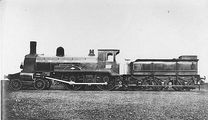 GERrailsoc's tweet photo. The Great Eastern Class 265 4-4-0 Locos
The No. 265 Class were large outside cylinder 4-4-0 locomotives built to the design of William Adams during his time as Locomotive Superintendent of the Great Eastern Railway from 1873 to 1878. Numbered 255 to 274, ten were constructed by Dübs and Company in 1876 and a further ten by R. W. Hawthorn and Company the following year. They have often been described as having been built for express passenger work but later relegated to goods trains. However, it would appear that they were intended for heavy goods and mineral trains by design. They were fitted with powerful steam brakes rather than the simple vacuum brake that the GER was beginning to use on express passenger services. These robust and powerful locos, popularly known as Ironclads, had 18" by 26" cylinders, 6' 1" coupled wheels, a boiler pressure of 140 psi, and weighed in at around 45 tons. Trials on very heavy coal trains led Adams to produce his famous Moguls, the Class 527 2-6-0s, which were the first locomotives of that wheel arrangement to run in Britain. None of the Ironclads were reboilered, but they lasted for over twenty years and were all scrapped between 1894 and 1897.