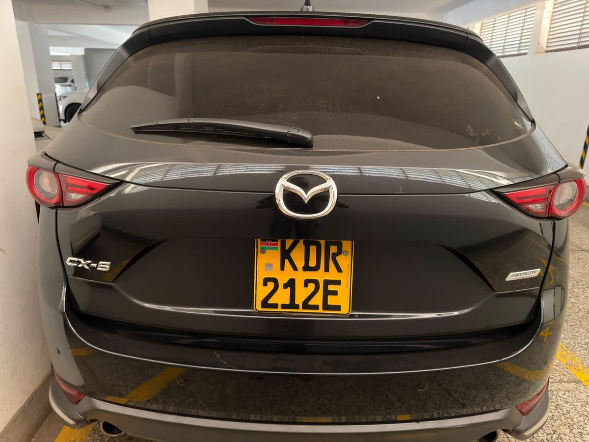 alexmwanzo's tweet photo. Here are the specs of the car:

Year of manufacture: 2019
Model: CX-5 25S L Package
Import Year: 2024
Mileage at import: 48,000Kms
Current Mileage: 66,000Kms
Colour: Black
Engine Size: 2.5L
Engine Type: Petrol (Non-Turbo)
Wheel Size: 19 inch
Drive system: Front Wheel Drive
Drive selection modes: Sport 

Self imported. Import documents and service history since import present.

Automatic rear liftgate
Dual climate control at the front
Heated steering
Heated seats at the front and rear
2 USB ports at centre console and two in the rear middle console
2 cigarette lighter ports. One in centre console and one under climate control buttons at front

Built-in Wired Android Auto/Apple Carplay
Came with dashcam (Language is in Japanese) Records front and back.

Parking sensors (8 in total: 2 centre front, 1left front, 1 right front, 2 centre back, 1 left back, 1 right back)
360° camera
Driver HUD projection to windshield.

No spare tyre just tyre repair kit

Mazda Safety and Driver support features present:
1. Adaptive Front Lighting System (AFS)
2. High Beam Control System
3. Blind Spot Monitoring
4. Traffic Sign Recognition System
5. Distance Recognition Support System (DRSS)
6. Rear Cross Traffic Alert (RCTA)
7. Mazda Radar Cruise Control with Stop & Go function
8. Lane-keep Assist System
9. Lane Departure Warning System
10. Advanced Smart City Brake Support

Asking 3.1m 
Being sold by @DerrickUdu55582  
+254 799 561061