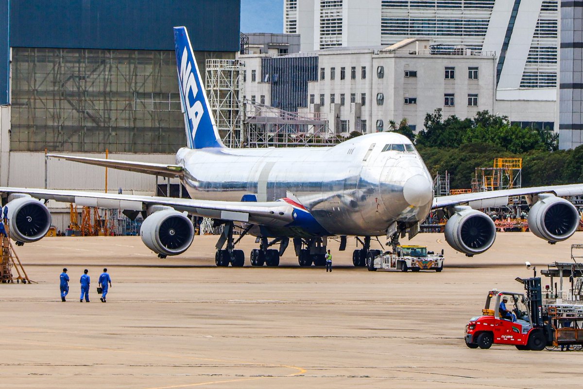 Fahadnaimb's tweet photo. Just rolled out of the hangar at Xiamen AirTech and  this absolute unit in bare metal.

NCA’s 747-8F looking pure silver under the afternoon sun...This one is still waiting for its new coat of paint.
Queen of the Skies in her rawest form. There’s something special about seeing these big freighters stripped down before they disappear back into the system.