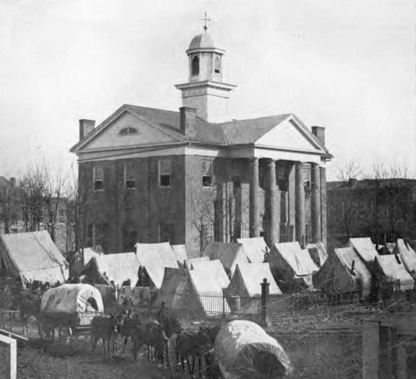 CaptLowry's tweet photo. OXFORD, MISSISSIPPI, and HER TWO COURTHOUSES

"But above all, the Courthouse: The center, the focus, the hub; sitting looming in the center of the County's circumference like a single cloud in its ring of horizon, laying its vast shadow to the uttermost rim of the horizon; musing, brooding, symbolic and ponderable, tall as a cloud, solid as a rock, dominating all"

William Faulkner - Requiem For A Nun, 1950

The original Courthouse (1840) on the left, during the December 1862 yankee occupation of Oxford. Shown are yankee wagons and tents. It was burned on August 22, 1864, by Union General A. J. Smith, because he could not catch Confederate General Forrest. This is the only picture we have of the original Lafayette County Courthouse. It was taken by a Northern photographer following the Union Army.

The "new" Courthouse, on the right, built in 1872, with federal money. It still is in use today, with two 1920's added wings. The exact plan for this courthouse was also used by the same contractor in Holly Springs, Mississippi, and in Bolivar, Tennessee. All three counties are on the old Mississippi central Railroad, in a row, North to South!