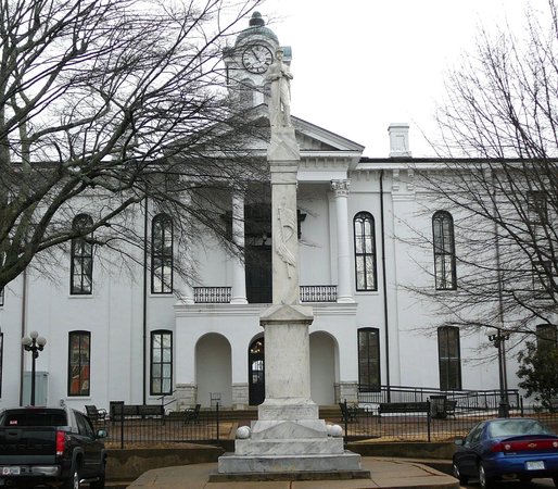 CaptLowry's tweet photo. OXFORD, MISSISSIPPI, and HER TWO COURTHOUSES

"But above all, the Courthouse: The center, the focus, the hub; sitting looming in the center of the County's circumference like a single cloud in its ring of horizon, laying its vast shadow to the uttermost rim of the horizon; musing, brooding, symbolic and ponderable, tall as a cloud, solid as a rock, dominating all"

William Faulkner - Requiem For A Nun, 1950

The original Courthouse (1840) on the left, during the December 1862 yankee occupation of Oxford. Shown are yankee wagons and tents. It was burned on August 22, 1864, by Union General A. J. Smith, because he could not catch Confederate General Forrest. This is the only picture we have of the original Lafayette County Courthouse. It was taken by a Northern photographer following the Union Army.

The "new" Courthouse, on the right, built in 1872, with federal money. It still is in use today, with two 1920's added wings. The exact plan for this courthouse was also used by the same contractor in Holly Springs, Mississippi, and in Bolivar, Tennessee. All three counties are on the old Mississippi central Railroad, in a row, North to South!