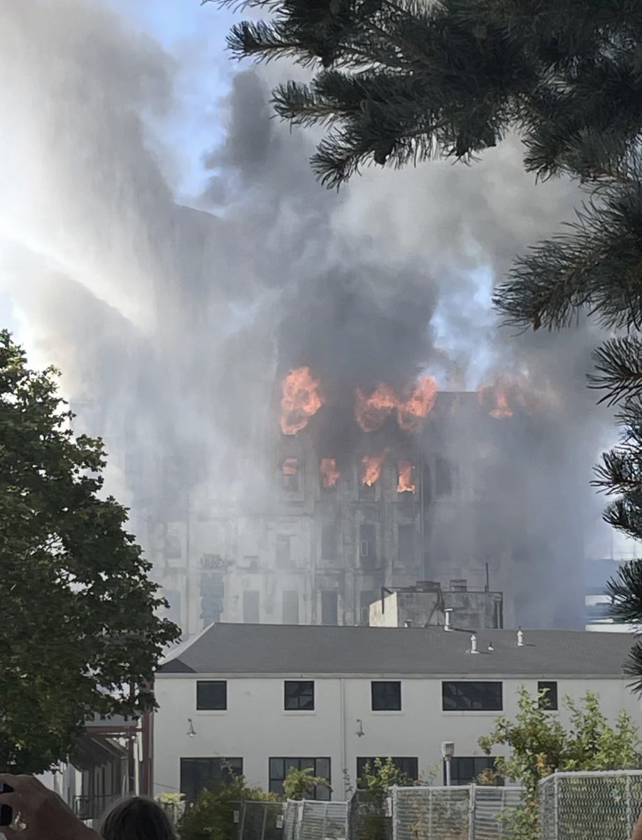 PDXReal1's tweet photo. Massive fire at the old Centennial Mills building in NW Portland has completely engulfed the building. A few weeks ago, the property was recently discussed as being a new residential development and nightclub. https://t.co/0GI5xpnkKH