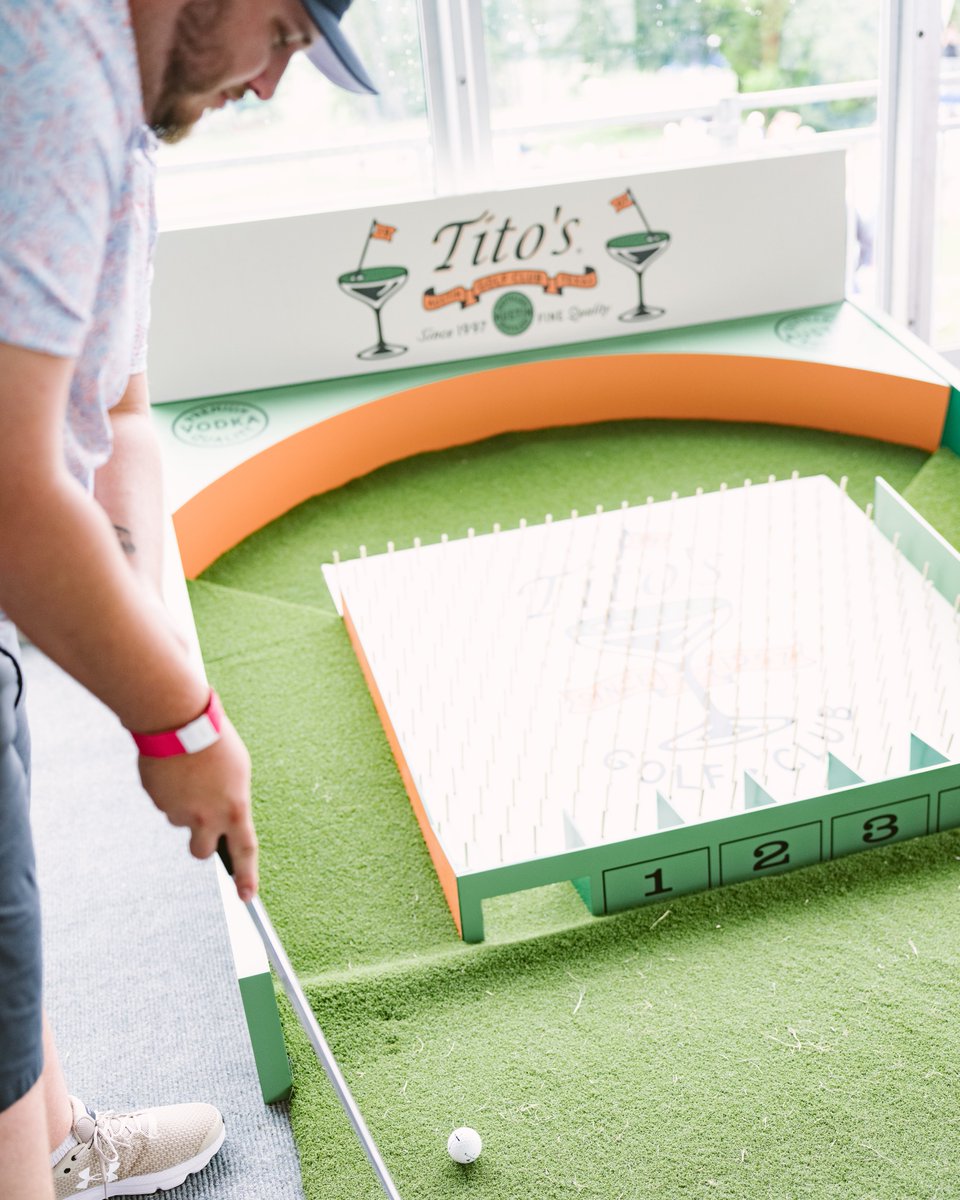 GORaymondJames's tweet photo. Swing by the @TitosVodka Golf Club, located between 10 green and 18 tee, for all the clubhouse perks—plus putting plinko, giveaways, a birdie-worthy view, and (most importantly!) air-conditioning. https://t.co/kLh7vYIvnH
