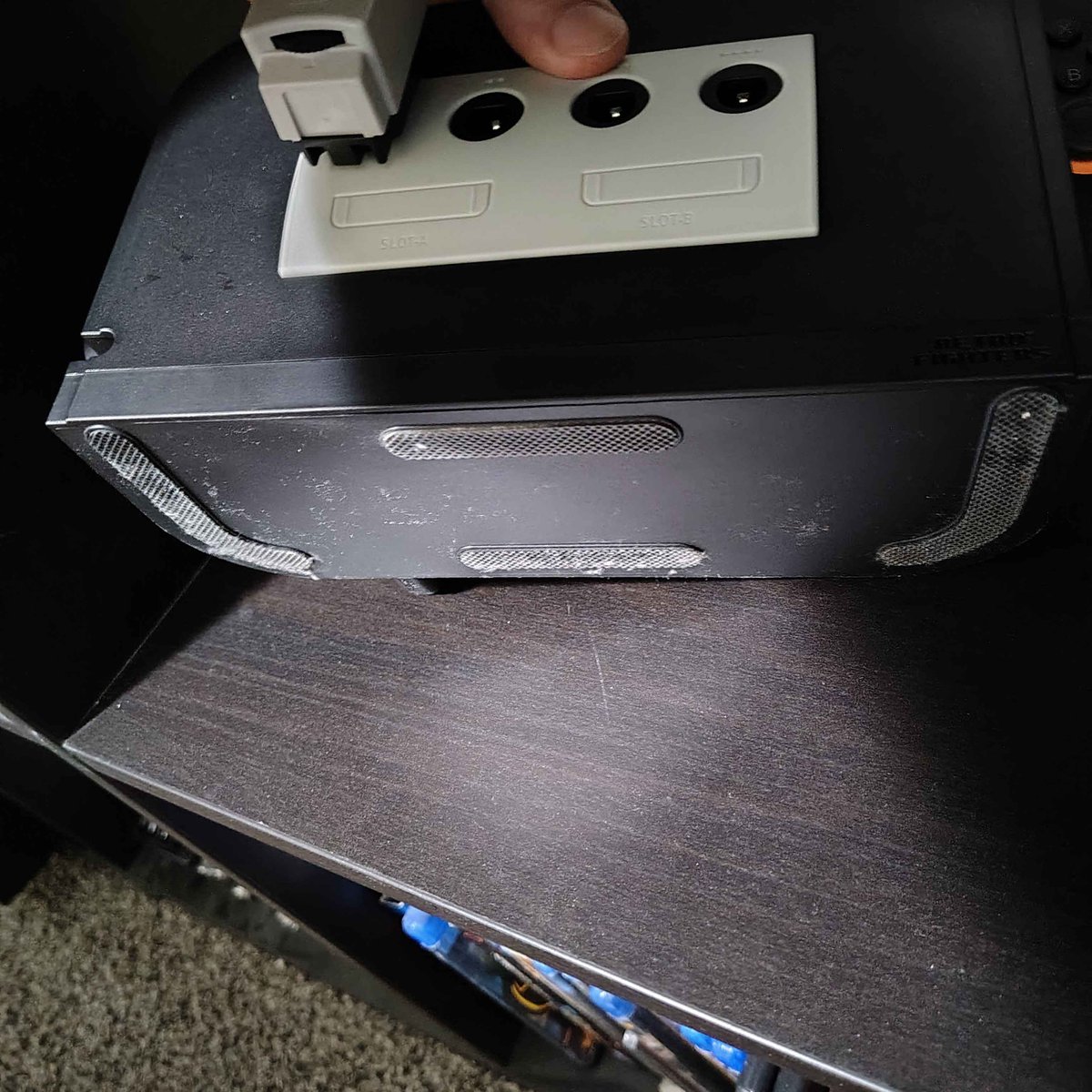 lylat64's tweet photo. @Yhandor @LiquidHbox @retrofightersco I'm not going to throw my controller lol, but here's a photo of the grip on the bottom. It is pretty substantial. Ignore the dust... it generates every time I look away in Utah. https://t.co/JmReTMsuYT