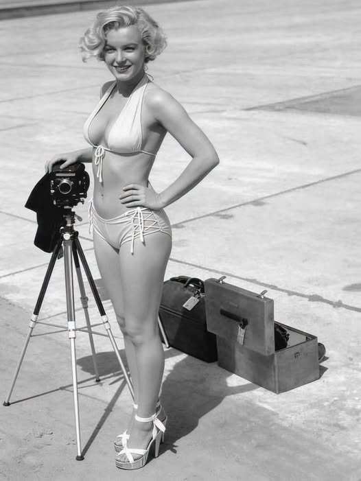 pierpi13's tweet photo. Cosa pensava Marilyn Monroe su Johnny Hyde, celebre agente dell'agenzia William Morris che ebbe un ruolo fondamentale nel lancio della sua carriera.
"Hyde diceva che sarei diventata una grandissima stella. Ricordo che scoppiai a ridere e gli risposi che non sembrava affatto possibile, visto che non riuscivo neanche a guadagnare abbastanza per pagare la bolletta del telefono.
Lui mi disse che aveva scoperto Lana Turner e che ...
io avevo qualcosa in più di Lana".
Qui, la foto mostra la Monroe durante un celebre servizio fotografico in bikini del 1951, realizzato negli studi cinematografici della 20th Century Fox.
Nello scatto, la diva posa sorridente accanto a una fotocamera professionale vintage montata su un treppiede, incarnando lo stile pin - up e il glamour della Hollywood dell'epoca .