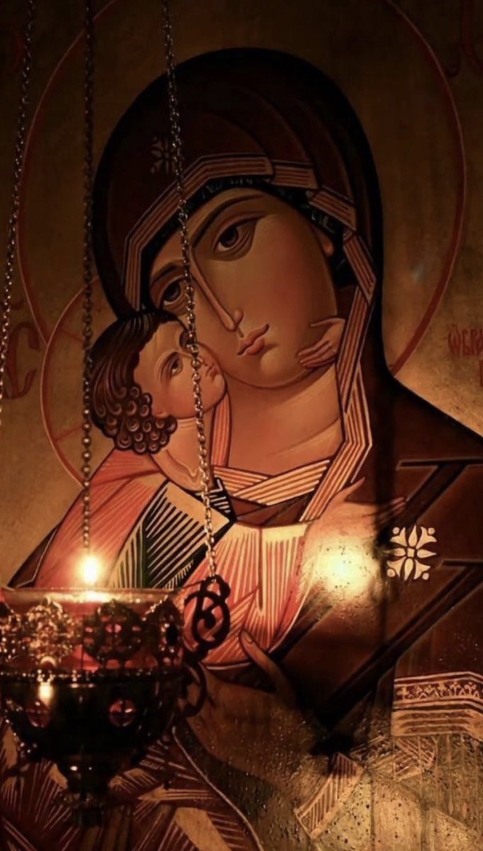 FChristopher77's tweet photo. It is said, dear ones, that on a Sunday during the Dormition Fast of the Mother of God, at a mountain monastery, an old monk placed three prayer lists before the icon of the Mother of God: one for the sick, one for divided families, and one for those who no longer had hope. 

That same morning, a weary doctor, a mother with a sick child, and a wealthy man who had not spoken to his brother for years had come to the church. At the end of the Liturgy, the old man gave each of them a piece of prosphora and said: “Do not leave each with only his own pain. Take also the pain of the other.”

The doctor set off toward the city, but on the mountain road he found a car stopped. Inside was that mother’s child, seized by a severe crisis. He helped him near a wayside cross until the ambulance arrived. 

The rich man, who was coming behind them, gave his coat for the child, took the mother to the hospital, and paid for the medicines without giving his name. When he arrived there, he learned that his brother had been admitted to the same place. After years of silence, they met in the corridor and embraced without explanations. 

At the same time, in the monastery, the lamp before the icon, extinguished by the wind, lit again from the still-living wick.

In the evening, the child was out of danger, the brothers had reconciled, and the doctor returned to the monastery and said: “I did not see the heavens open, but I saw people change.” 

The old man smiled: “This is how the Mother of God sometimes works. She does not move mountains from their place, but moves hearts, so that people may pass together over the mountains.” And the icon remained in silence, but each one left with his own answer.
