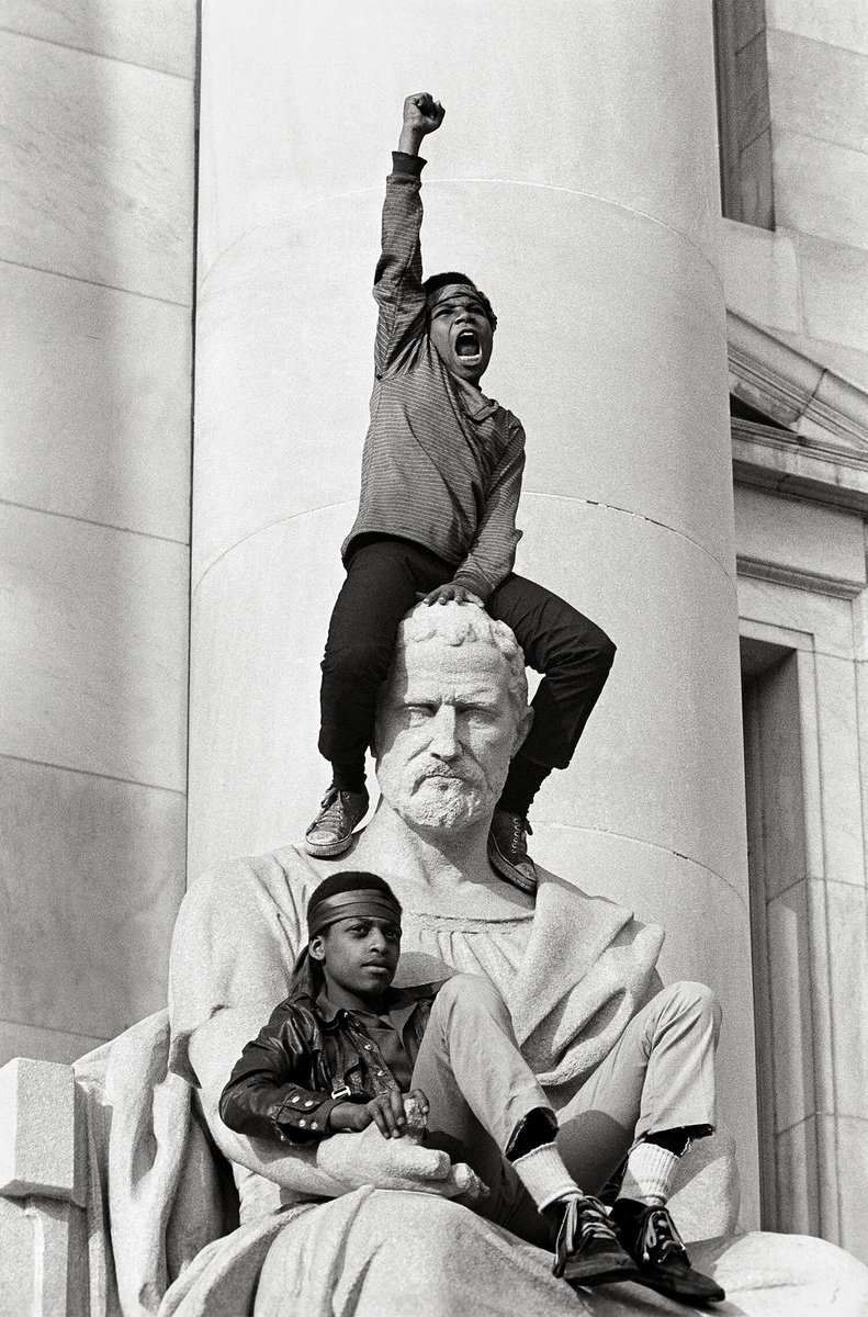 AfricanArchives's tweet photo. Boy gives raised fist salute on a statue in front of the New Haven county courthouse during a protest in Connecticut, 1 May 1970. https://t.co/9jFc3qQnqE
