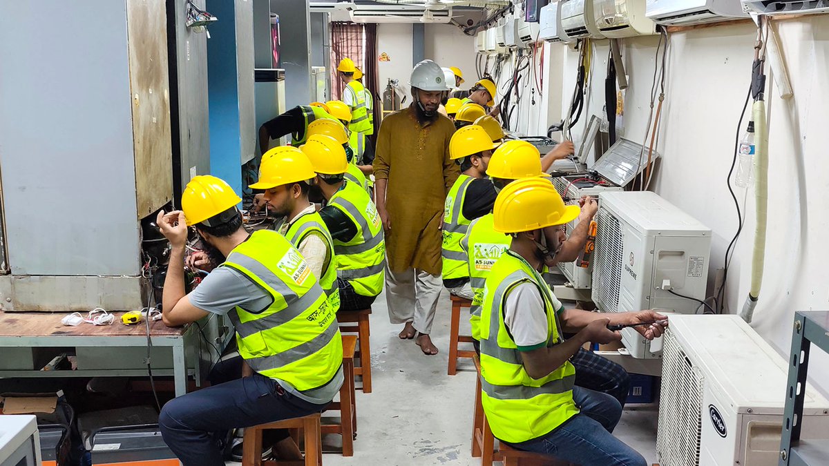 assunnahskill's tweet photo. Someone is peering inside an AC with a screwdriver in hand, while others are busy working on a refrigerator compressor. https://t.co/3qKmqilimg