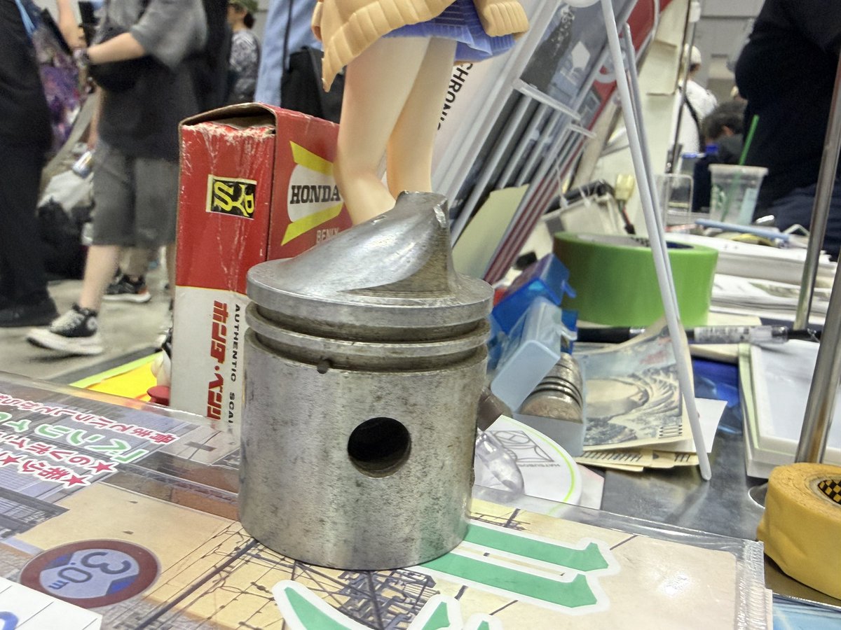fudosha_net's tweet photo. 飾りで置いてる変なピストンが人気。デフレクターピストンと言います。

これはメイハツのもので、確か125-60、いわゆるB6のもの。 https://t.co/Wv0P9hIVjo