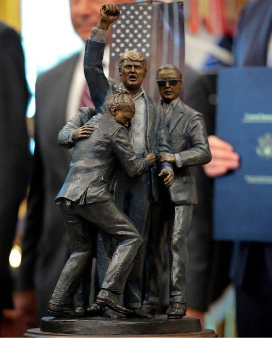 RossKneeDeep's tweet photo. We watched as the Secret Service allowed an American flag to be lowered in slow motion, above their heads into the backdrop for the perfect photo shoot of a president during an attempted assassination. 

Not only did the Secret Service allow this coward to raise his head during the incident, they allowed him to pop up and pump his fist and yell fight, fight, fight. 

They next thing you know, he's making t-shirts, flags, caps, having gold coins minted. There's even a painting and a bronze sculpture of the incident in the White House. 

You can't tell me that this wasn't just another faked business opportunity for a world class grifter. There was no danger. There was to threat to his life.

From that moment on, everything he's does has to be looked at through a side-eye.

After all, he's a reality TV show ringmaster.