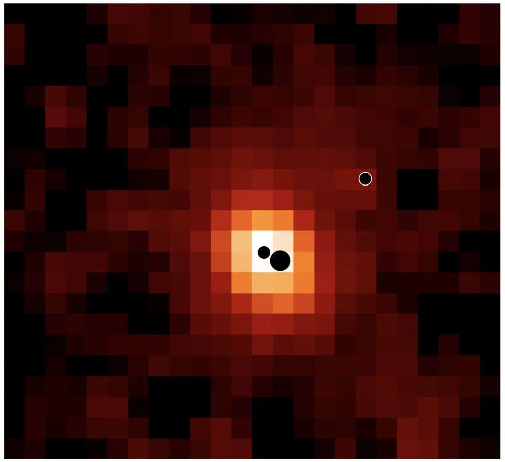 konstructivizm's tweet photo. JWST found, for the first time, a galaxy with 3 supermassive black holes
A cosmic family portrait, painted in glowing hydrogen by the James Webb Space Telescope.

This is an ionized-hydrogen map of the distant galaxy J0148-4214. The three black circles mark its resident black holes (shown far larger than their true size for clarity). The most massive and the least massive of the trio sit closest together and are locked on a collision course, destined to merge in roughly 700 million years. The third, more distant black hole will join the dance later, completing a multi-stage gravitational waltz that has been unfolding for billions of years.

Credit: Hannah Übler