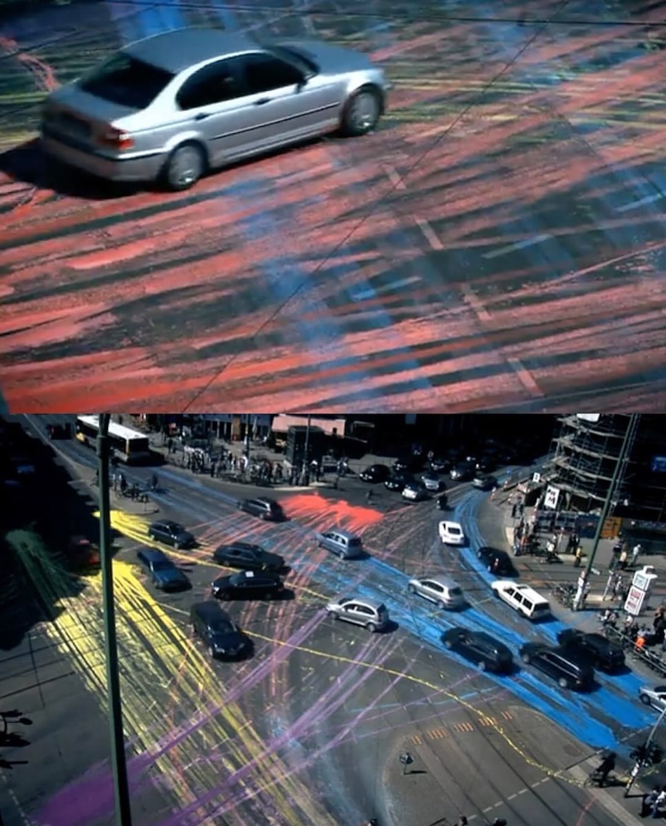 historyinmemes's tweet photo. In the early hours of an April morning in Berlin, artist IEPE and a group of collaborators transformed an ordinary intersection at Rosenthaler Platz into something completely unexpected.

Arriving by bicycle with buckets of brightly colored, water-based paint, they poured the colors across the asphalt before disappearing into the city. What happened next became part of the artwork as cars, bicycles, and pedestrians moved through the paint, constantly spreading and reshaping the colors.

The temporary installation turned the street into an ever-changing canvas, created by both the artists and the people passing through it. The non-toxic paint eventually washed away with the rain, but for a few hours, ordinary city life became a spontaneous act of collective art.