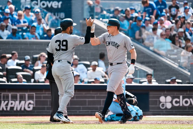 Ben Rice high-fives Ali Sánchez after hitting a home run in the 10th.
