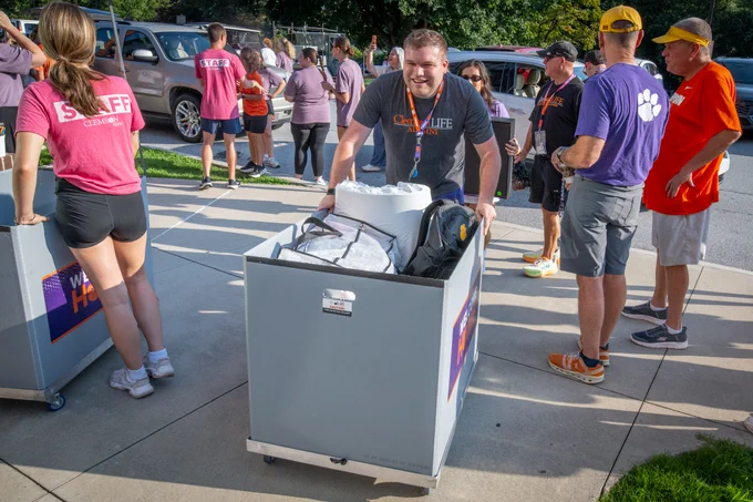 A student pushing a cart during move-in.