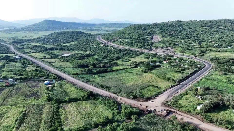 gladyswanga's tweet photo. BEYOND THE DUST: HOMA BAY'S LONG ROAD FROM MARGINALISATION TO TRANSFORMATION

The dust on the Mbita–Sindo–Kiabuya–Sori corridor tells a story. But it is not the story of a people who have failed. It is the story of a region that has waited far too long for the infrastructure required to unlock its potential.
What was billed as a tour of Homa Bay by Linda Mwananchi ended up doing something its organisers did not intend: it highlighted the very tribulations our community has been fighting to overcome. Rough roads in parts of Suba South became a visual metaphor, and a source of ridicule, for Homa Bay's exclusion from development (including by their main sponsor). For the people who live along these roads, however, their condition is no joke; it is a daily reality that shapes access to markets and services, the cost of doing business, and the pace at which communities can develop.

Homa Bay has lived with this reality for decades. Since independence, the county, like many others across the country, has been evidence of a structural deficit that stretches from God Odiado in Siaya to Wuoth Ogik in Nyatike, shared by Turkana, Maasailand, Western Kenya, the Coast and other regions that have waited since 1963 for a fair share of the republic. 

These regions have experienced acute economic marginalisation reflected in an infrastructure deficit far greater than what their population, resources and potential should have allowed. Those roads have their origins in independent Kenya, and their neglect spans every administration: fifteen years under Jomo Kenyatta, twenty-four under Daniel Arap Moi, ten under Mwai Kibaki, and ten more under Uhuru Kenyatta. It is a matter of historical record, not grievance for its own sake, that the roads Linda Mwananchi's cameras found so remarkable are the same roads generations of governments chose not to build. The Mbita road itself tells that story in miniature: first awarded in 2016 under the Uhuru Kenyatta government to Put Sarajevo, it stalled for lack of allocated funds, with only 7km of its 74km completed. It was re-awarded in 2020 and again saw little progress. In the last two years, 28km have so far been tarmacked, with works currently ongoing. It is important to note that a 74km trunk road is not something that devolution or CDF can address.

However, devolution matters. Some would ask what devolution has done? It is devolution, championed for decades by leaders including Raila Odinga, that has begun to give counties like Homa Bay a say over their own development and a share of resources once concentrated at the centre. This has turned the case for correcting marginalisation from a matter of goodwill into a constitutional guarantee.

We are not embarrassed by that history. If images of rutted roads earned Homa Bay comparisons to conflict zones, we take that as a badge of honour to our marginalisation and resilience, not an insult requiring our silence. We are convinced that these roads would have been tarmacked decades ago had Tom Mboya and Jaramogi Oginga Odinga remained in government. Jaramogi was forced out in 1966, Mboya assassinated in 1969, both on a path toward the presidency. Raila Odinga, many believe, would have delivered that infrastructure as president, but when Kenyans elected him, that mandate was denied to him by force. That history is why the current moment deserves to be judged on its own terms, not dismissed as political theatre.
